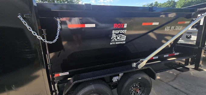 Bigfoot Site Services dumpster loaded with construction and demolition debris